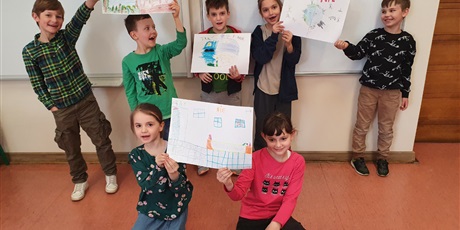 Powiększ grafikę: grupa uczniów trzyma w ręce swoje prace o tematyce ekologicznej 