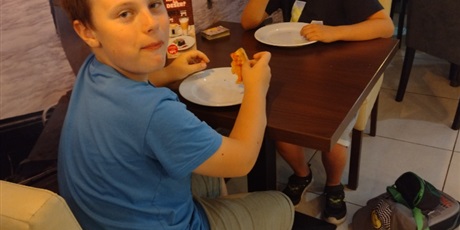 Powiększ grafikę: uczniowie klasy 3 jedzą pizze